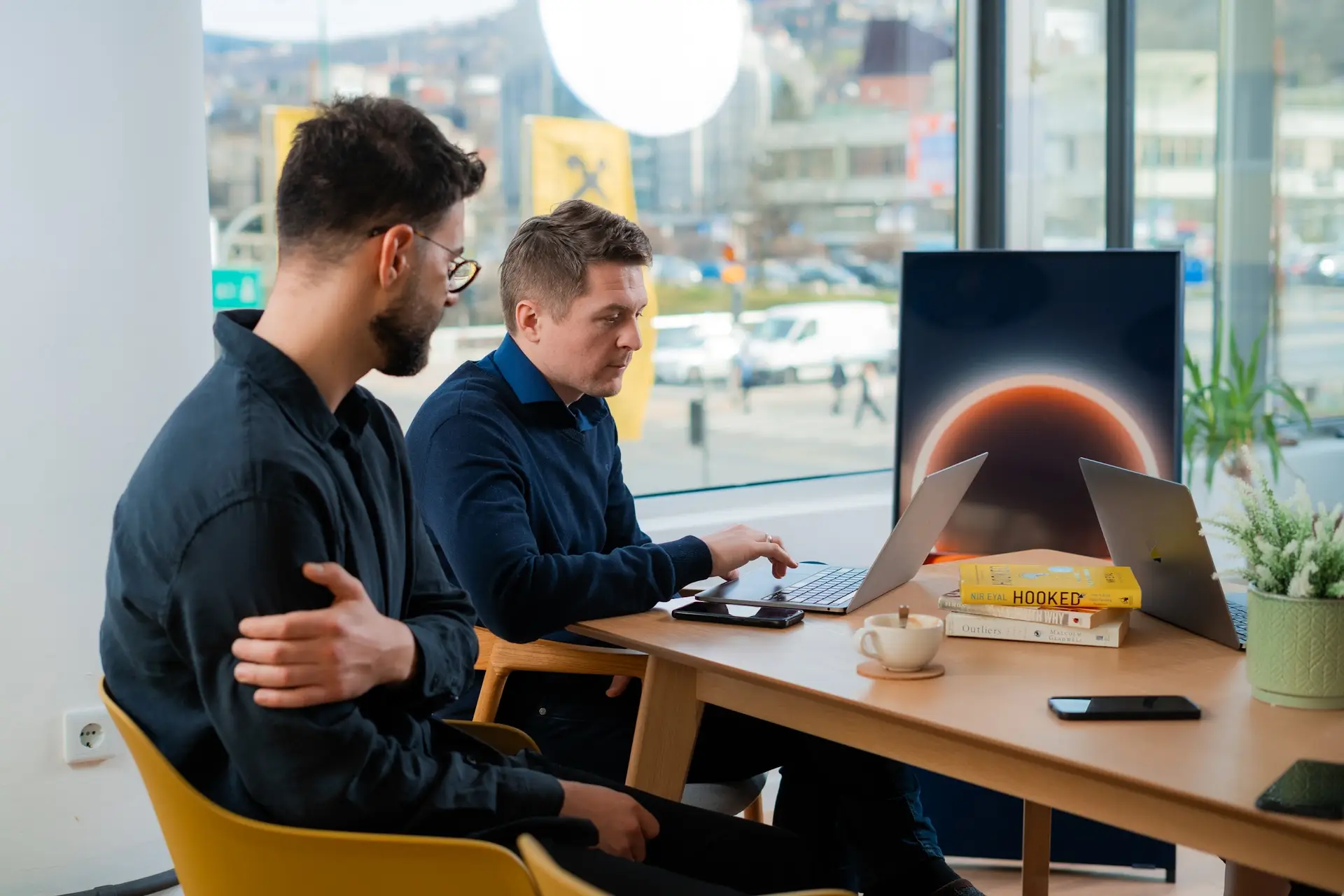 Two colleagues working in a beautiful and sunny conference room in Sarajevo's best coworking space.