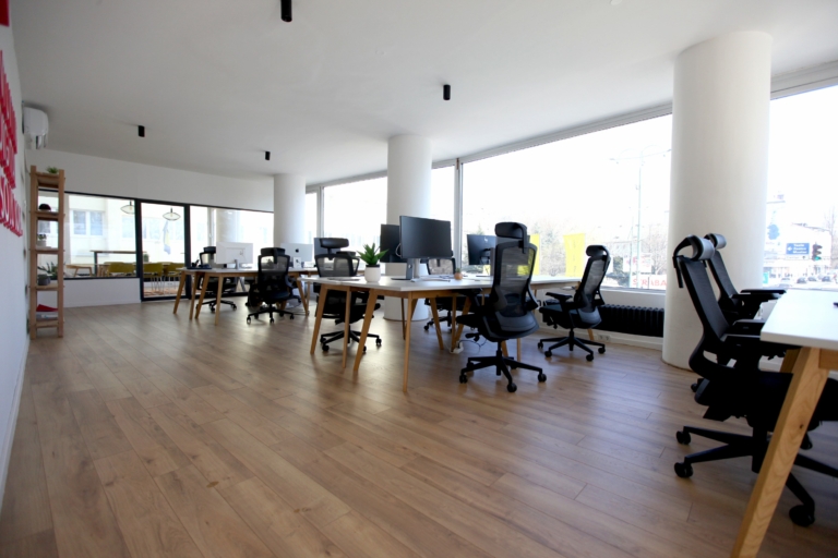Coworking space in Sarajevo with desks, monitors, and ergonomic chairs