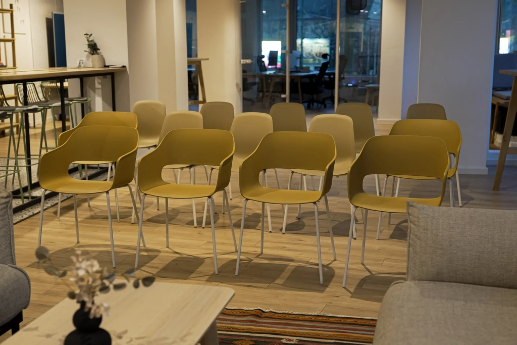 Rows of mustard chairs arranged theater-style for a workshop at Motiff coworking space"